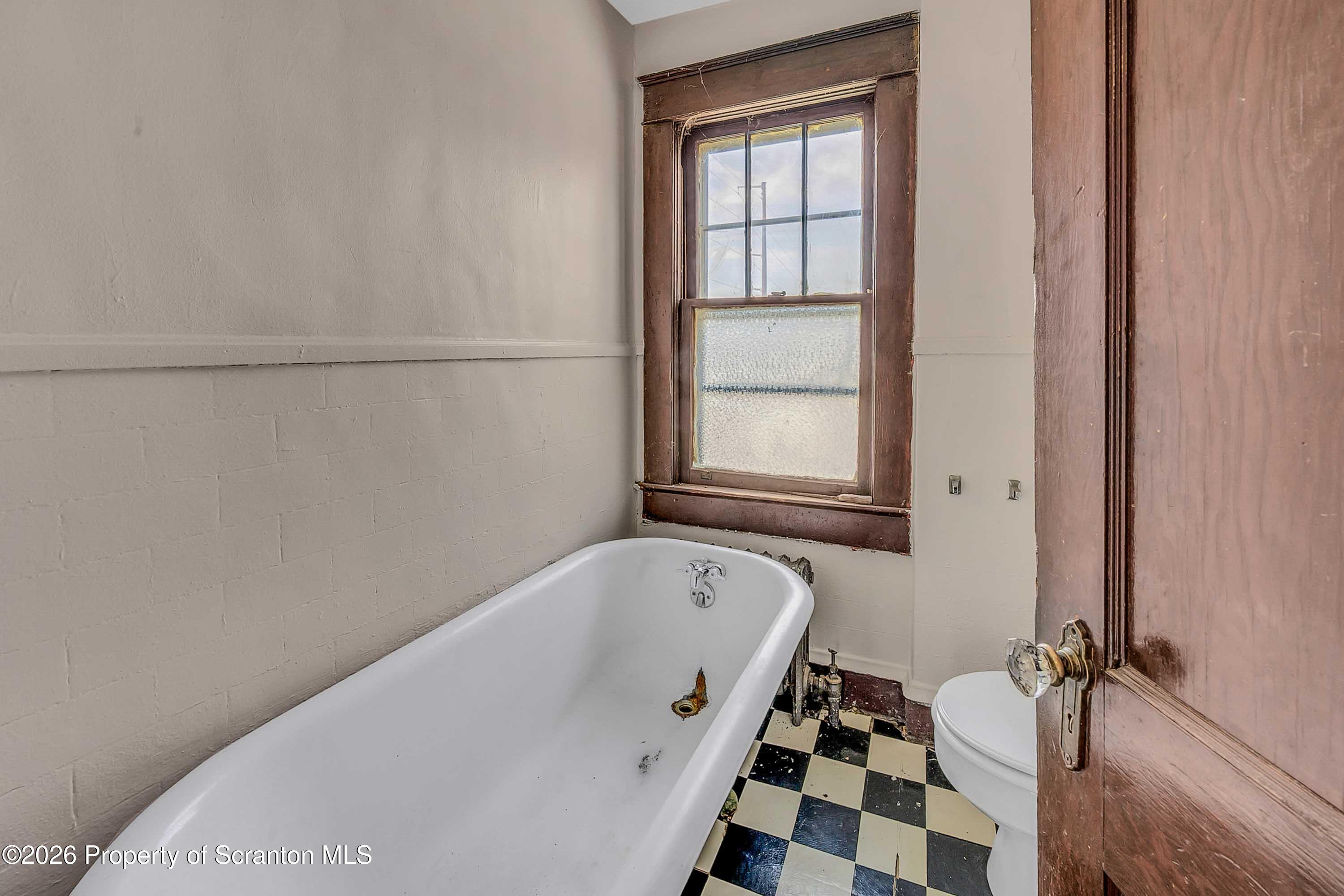 2309 Ash Street Scranton, PA 18510 - Photo 35 of 46 a bathroom with a bathtub and a window