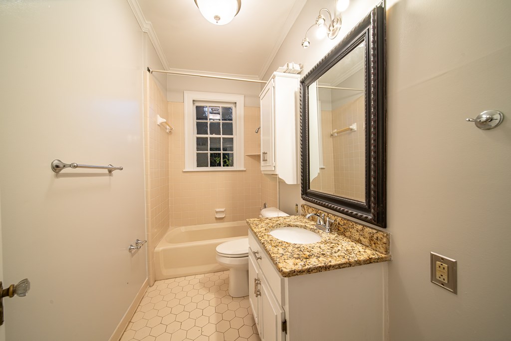2010 Cherokee Avenue Columbus, GA 31906 - Photo 21 of 54 a bathroom with a granite countertop sink toilet and shower
