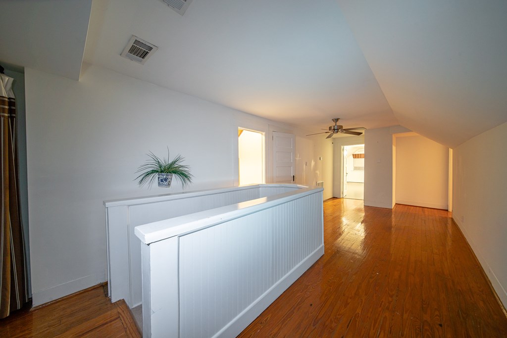 2010 Cherokee Avenue Columbus, GA 31906 - Photo 43 of 54 a view of a hallway with wooden floor and staircase