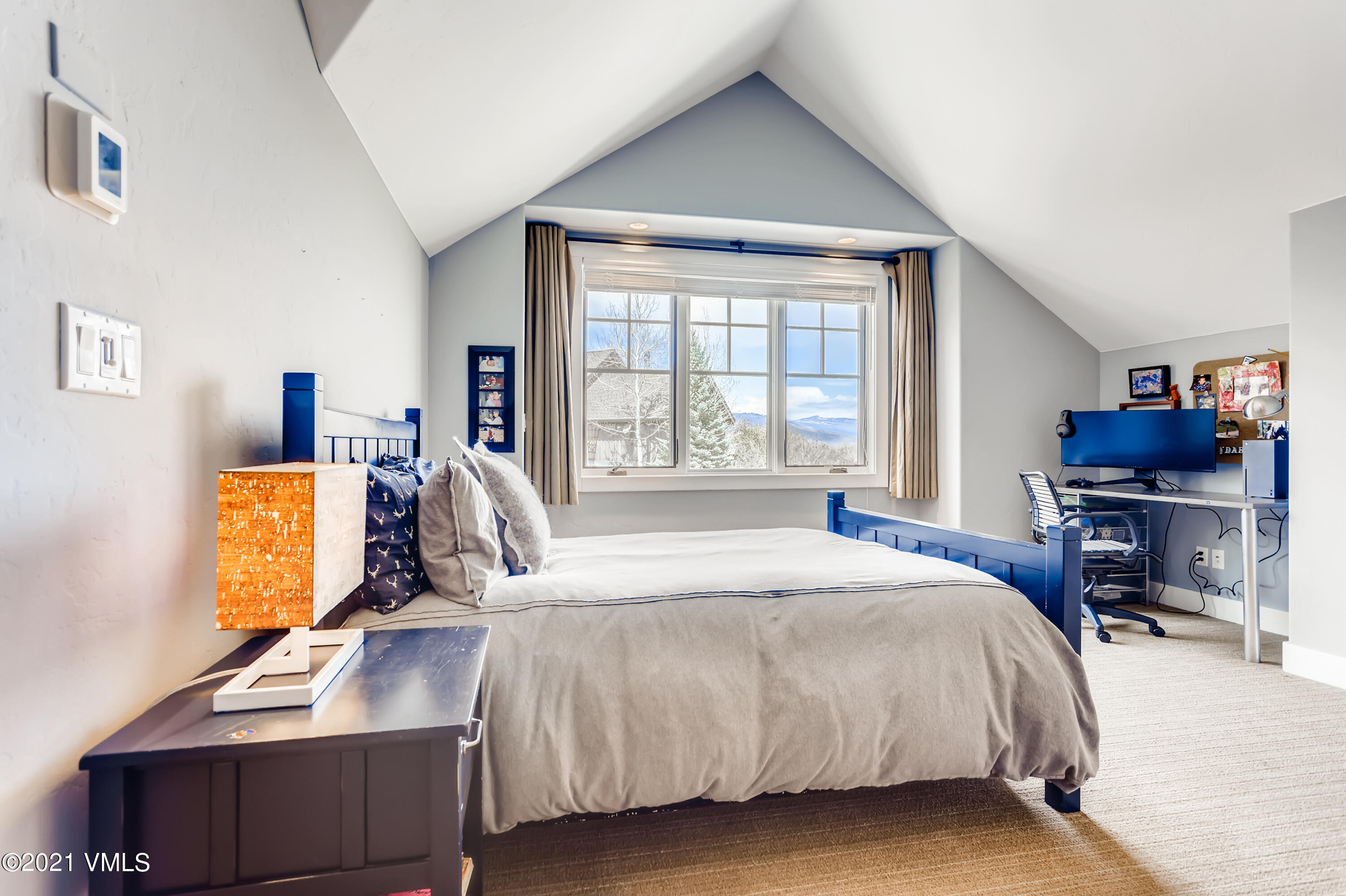 204 Remington Trail Edwards, CO 81632 - Photo 16 of 30 a bed room with a bed and a chair