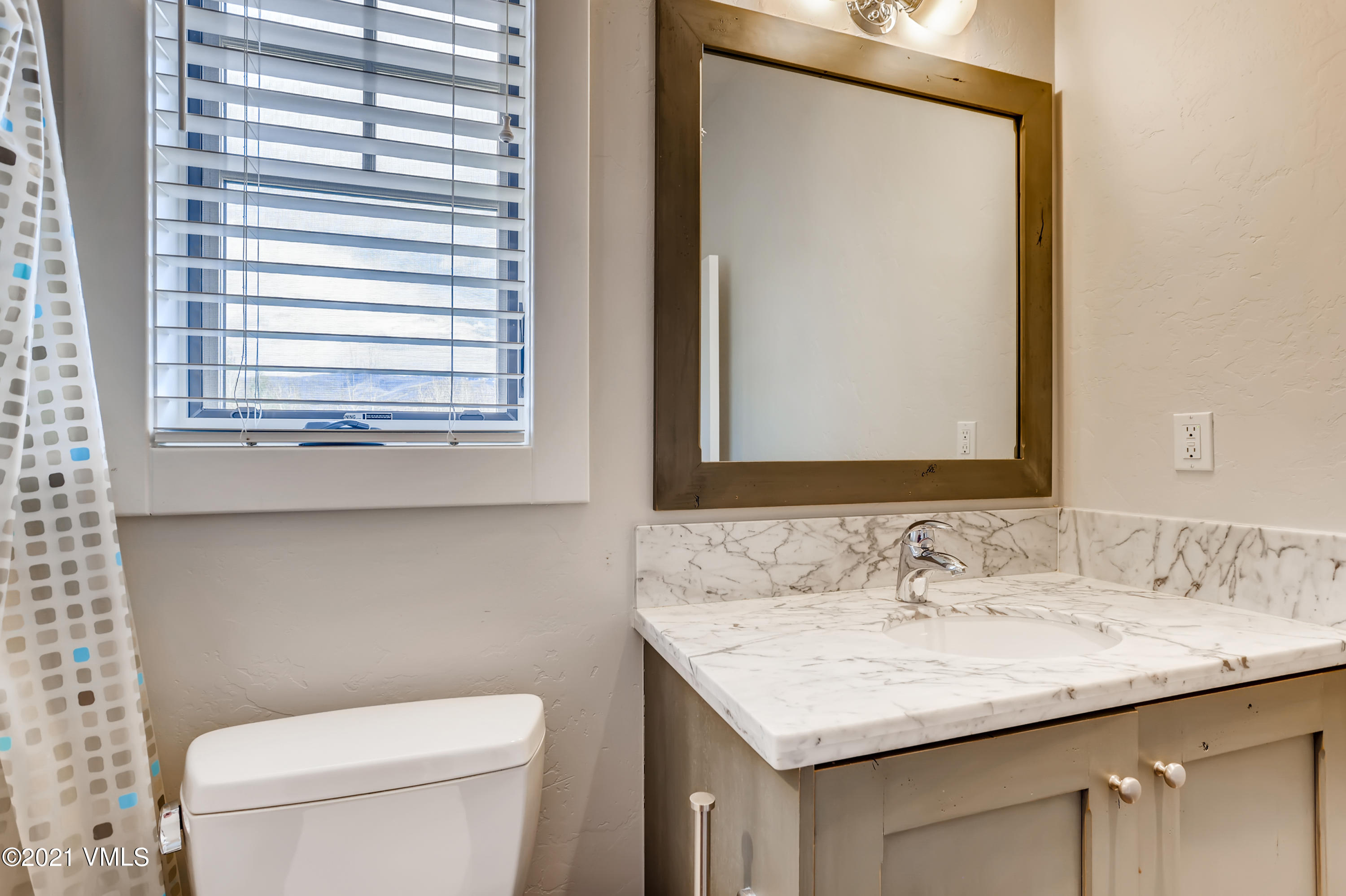 204 Remington Trail Edwards, CO 81632 - Photo 17 of 30 a bathroom with a granite countertop sink and a toilet