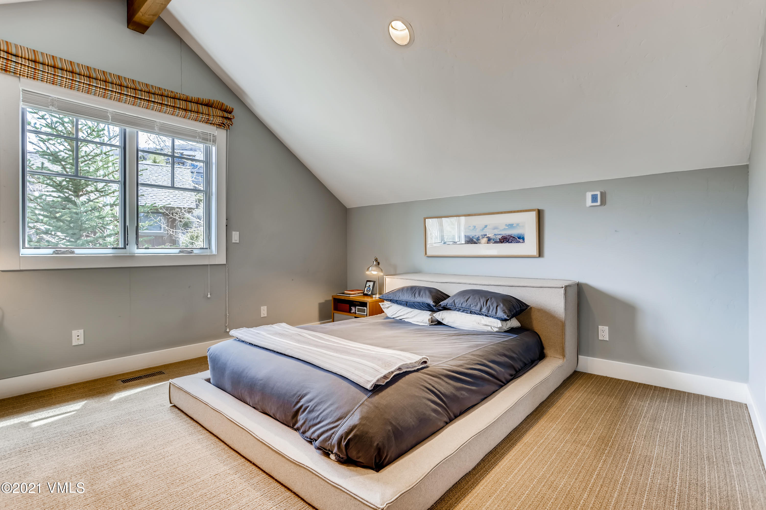 204 Remington Trail Edwards, CO 81632 - Photo 22 of 30 a bedroom with a bed and wooden floor