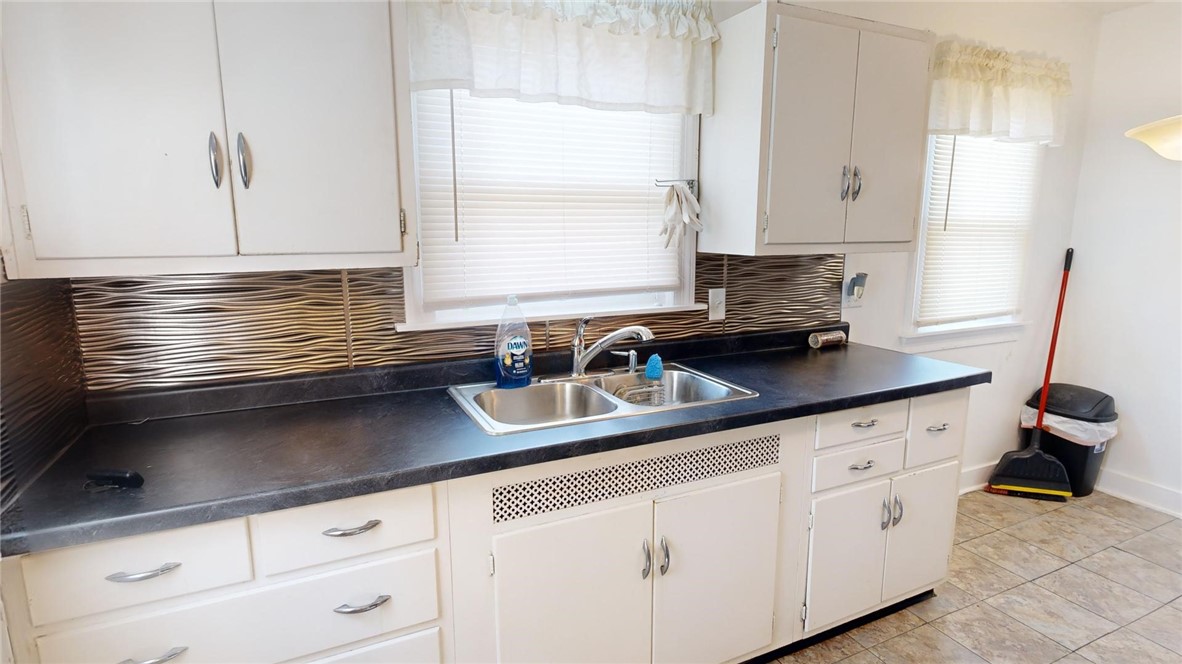 956 North University Avenue Decatur, IL 62522 - Photo 9 of 24 a kitchen with stainless steel appliances white cabinets a sink and a window
