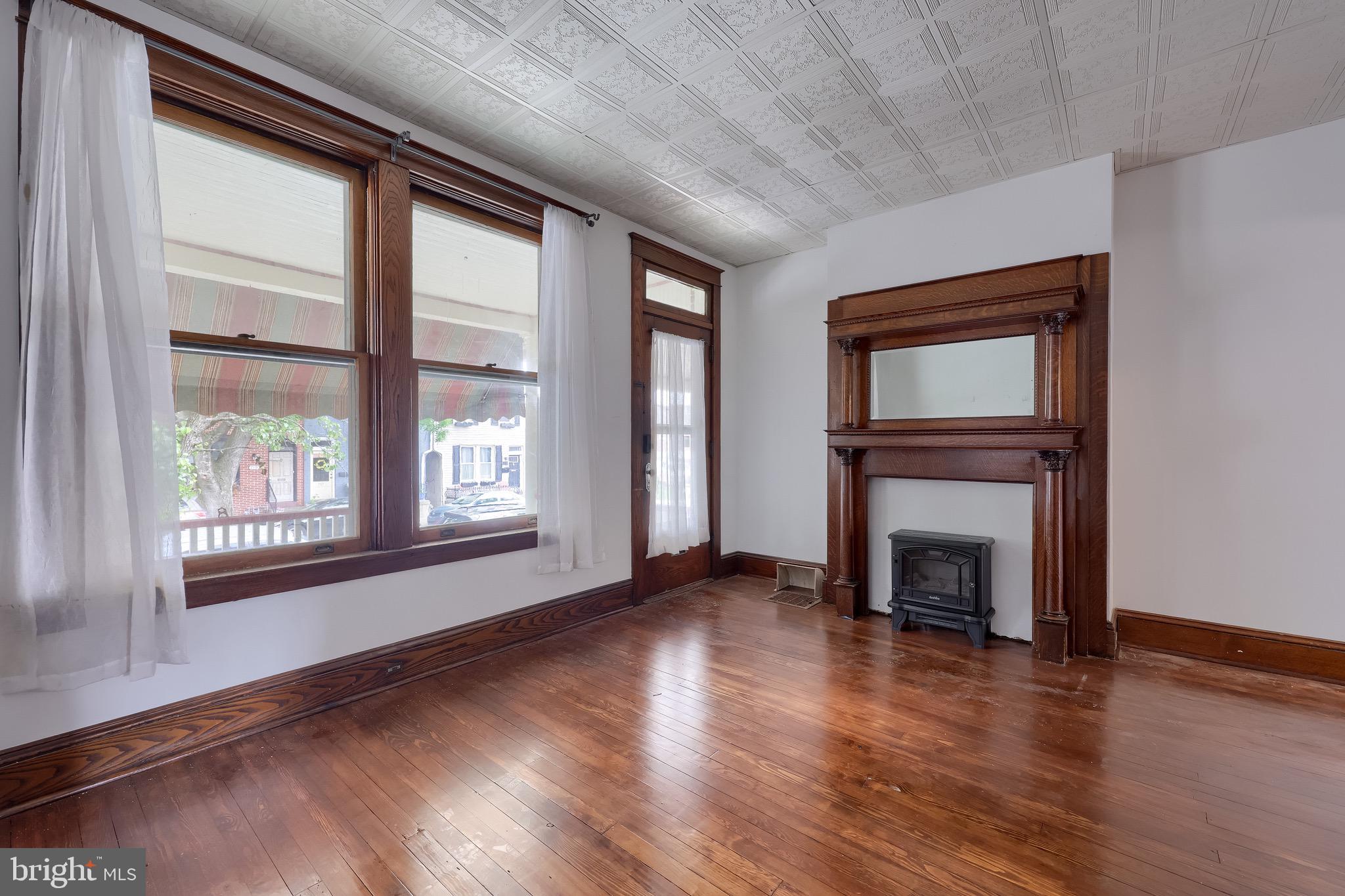 720 1st Street Lancaster, PA 17603 - Photo 12 of 50 a view of an empty room with wooden floor and a window