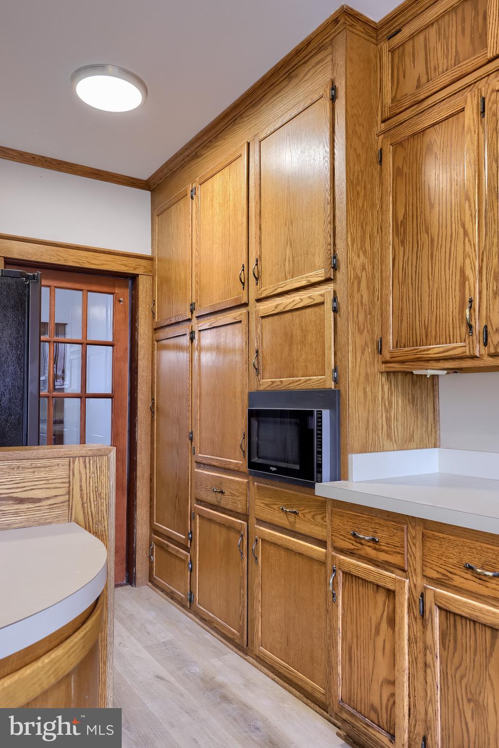720 1st Street Lancaster, PA 17603 - Photo 27 of 50 a kitchen with stainless steel appliances granite countertop a refrigerator a stove and white cabinets with wooden floor
