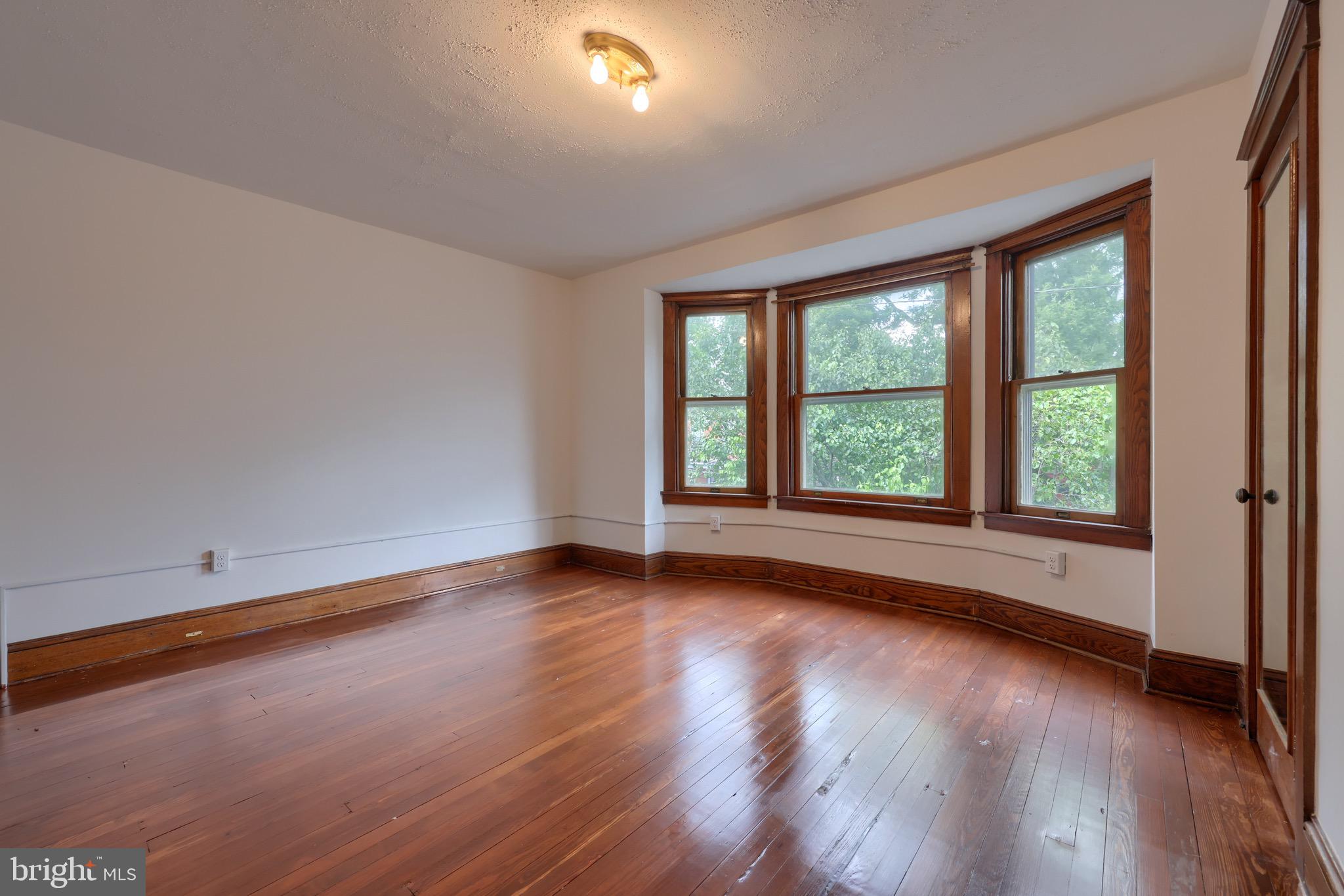 720 1st Street Lancaster, PA 17603 - Photo 37 of 50 a view of an empty room with wooden floor and a window