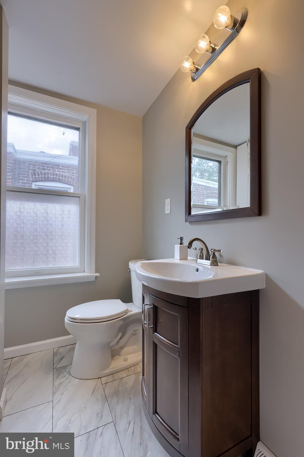 720 1st Street Lancaster, PA 17603 - Photo 41 of 50 a bathroom with a toilet sink and mirror