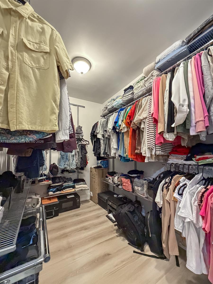 7840 Southwest 18th Terrace Miami, FL 33155 - Photo 12 of 28 a view of walk in closet with clothes and shoes