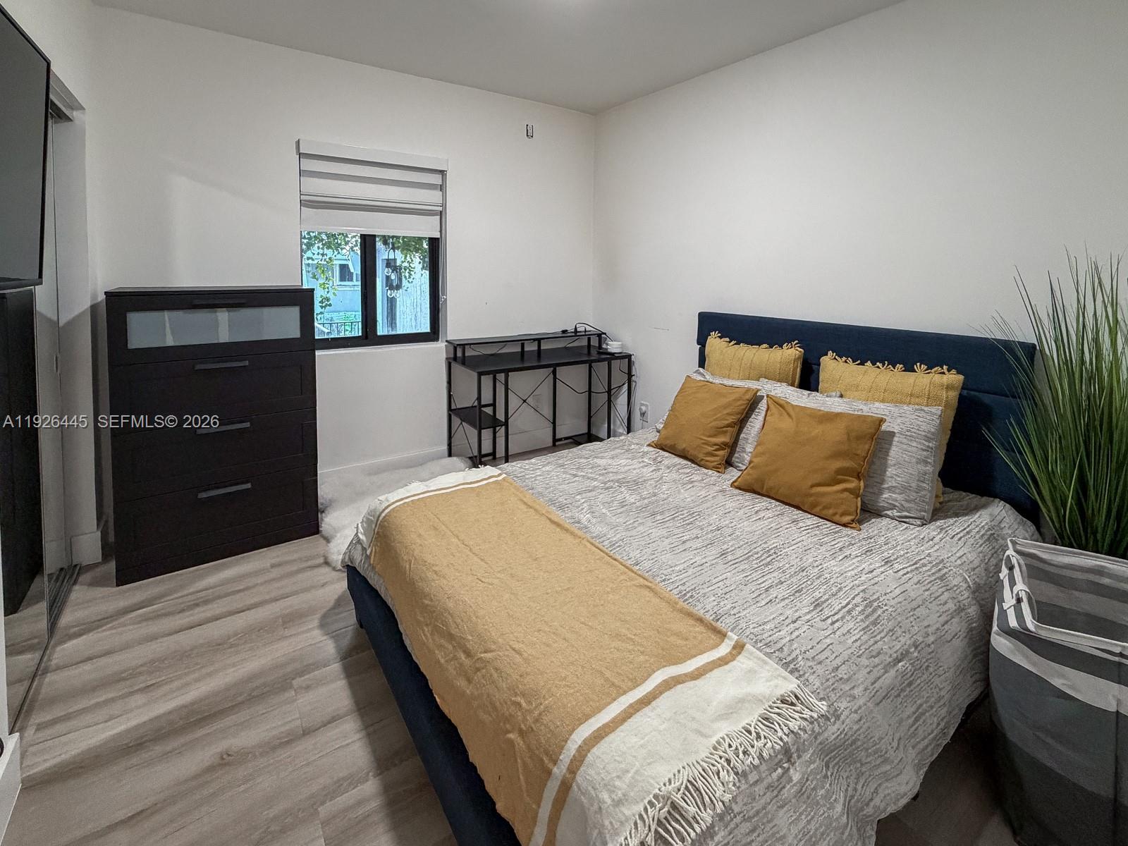 7840 Southwest 18th Terrace Miami, FL 33155 - Photo 16 of 28 a bedroom with a bed and a potted plant