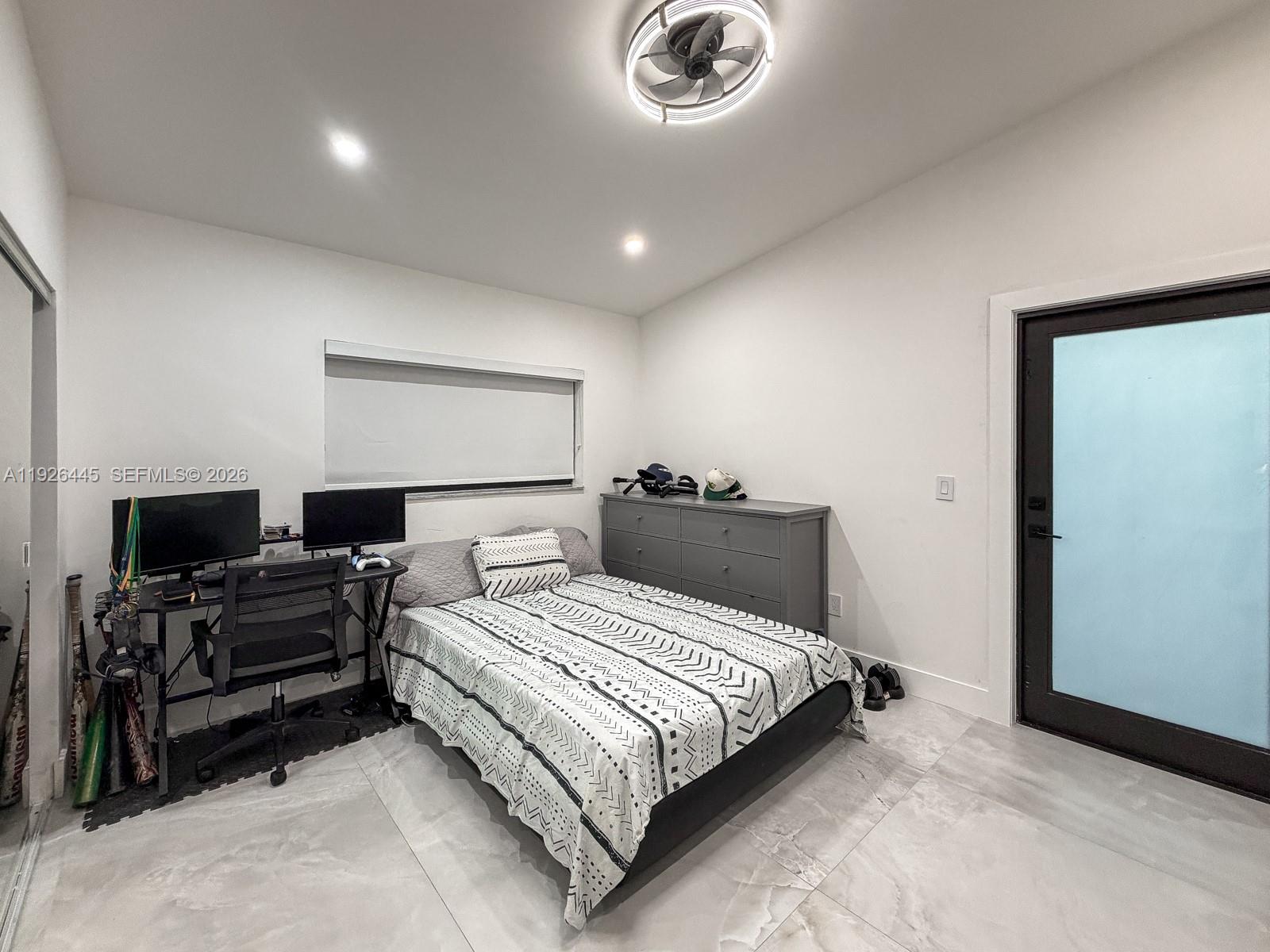 7840 Southwest 18th Terrace Miami, FL 33155 - Photo 17 of 28 a bedroom with a bed and a flat screen tv