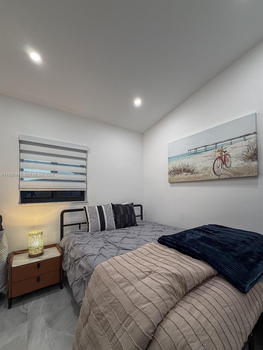 7840 Southwest 18th Terrace Miami, FL 33155 - Photo 18 of 28 a bedroom with a bed and wooden floor
