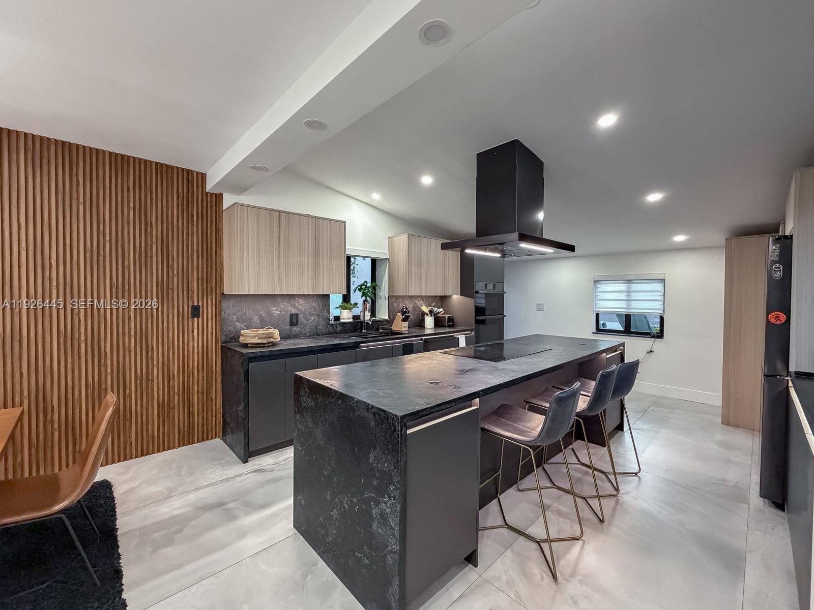 7840 Southwest 18th Terrace Miami, FL 33155 - Photo 2 of 28 a kitchen with stainless steel appliances granite countertop a table chairs sink and cabinets