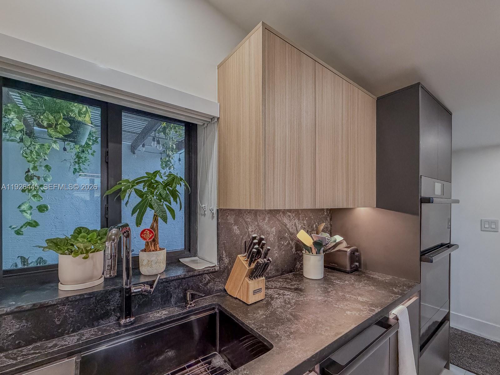 7840 Southwest 18th Terrace Miami, FL 33155 - Photo 3 of 28 a kitchen with a potted plant on the counter