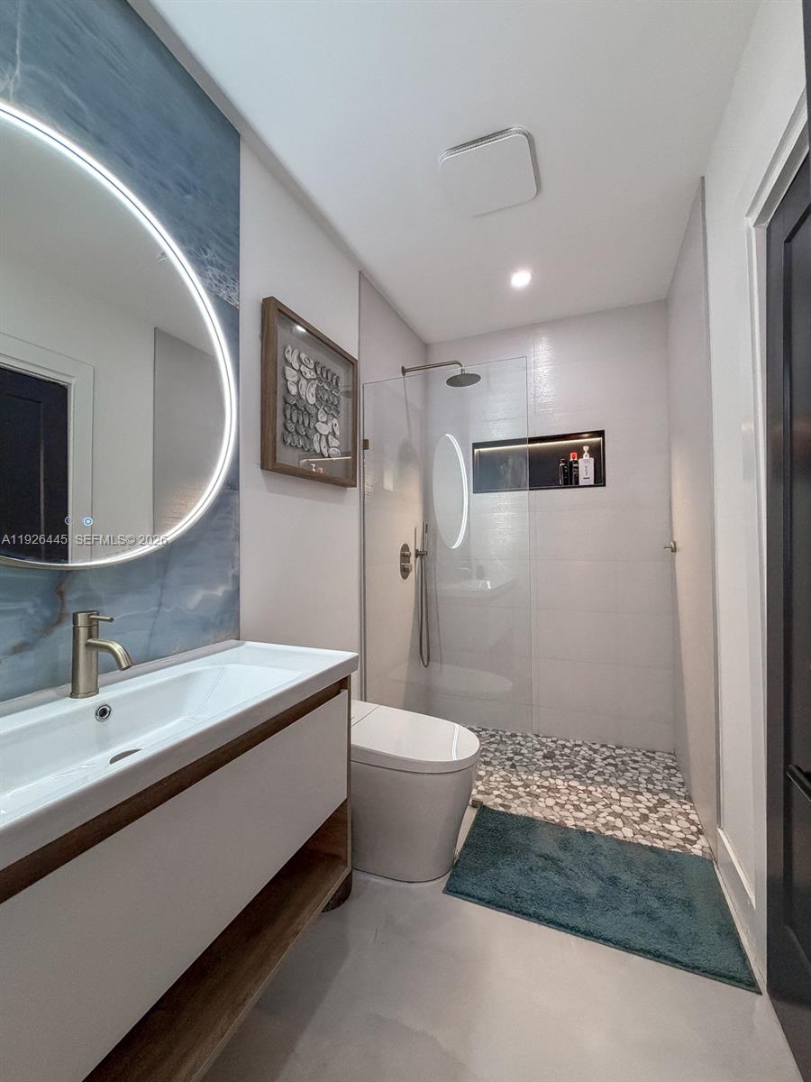 7840 Southwest 18th Terrace Miami, FL 33155 - Photo 7 of 28 a bathroom with a sink a toilet and shower
