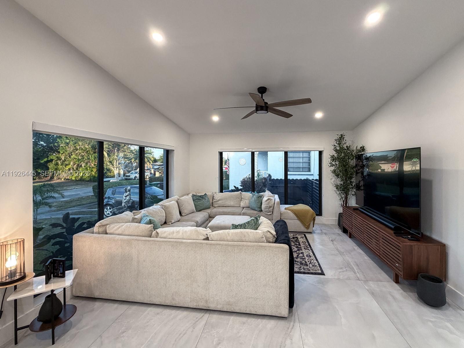 7840 Southwest 18th Terrace Miami, FL 33155 - Photo 8 of 28 a living room with furniture tv and a large window