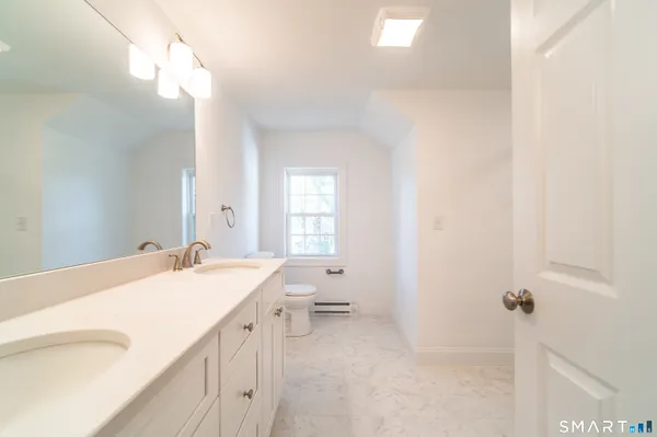 a spacious bathroom with a sink vanity tub and a mirror