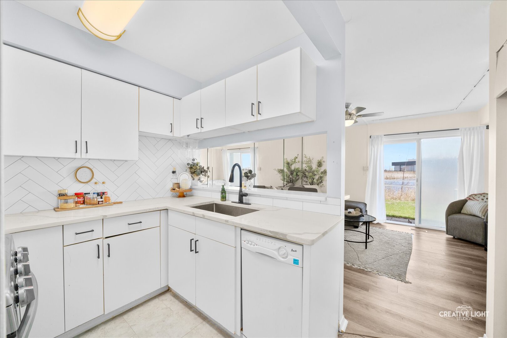 2437 Devonshire Court Aurora, IL 60502 - Photo 4 of 14 a kitchen with white cabinets and sink