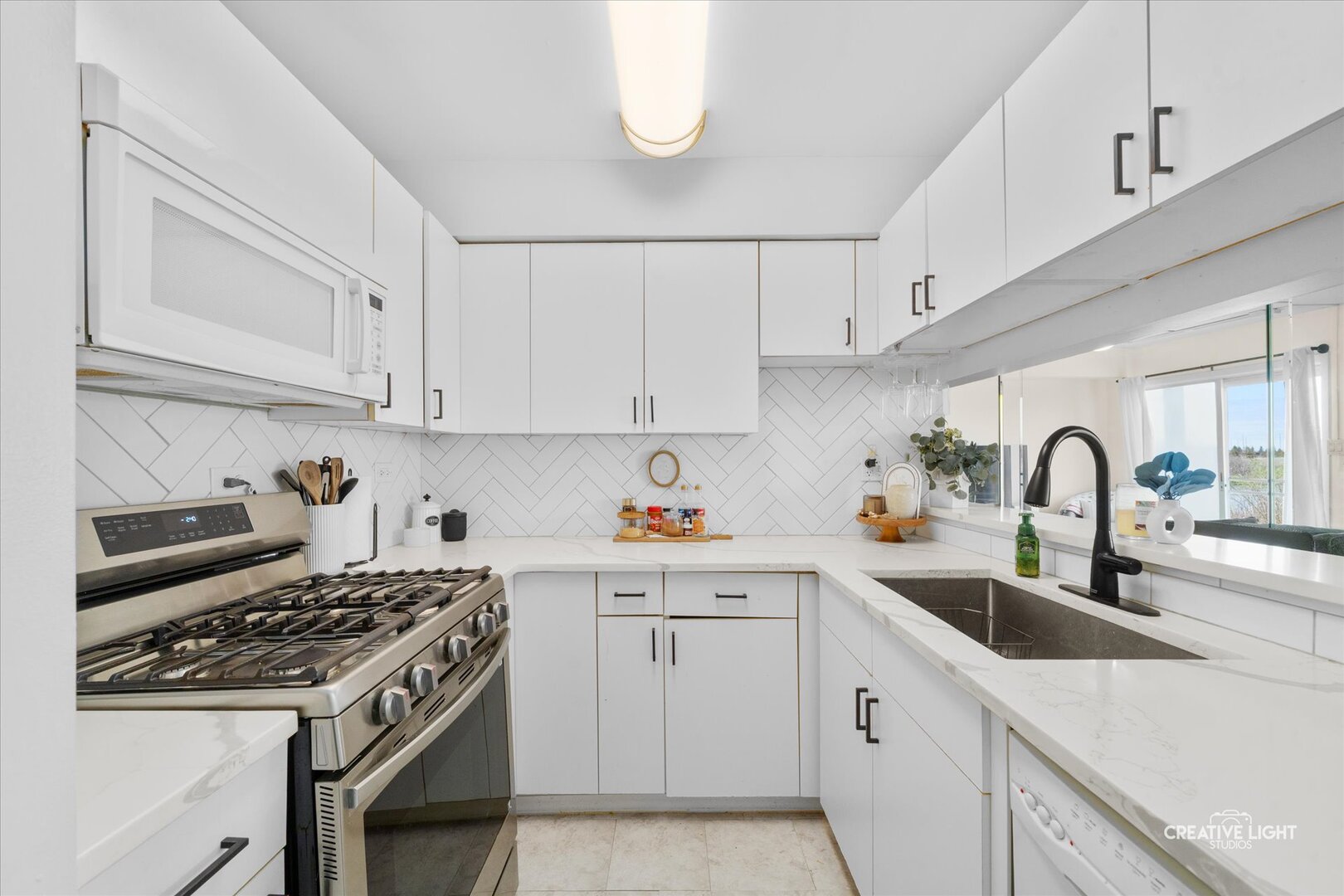 2437 Devonshire Court Aurora, IL 60502 - Photo 5 of 14 a kitchen with white cabinets a sink and white appliances