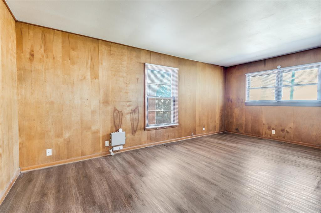 402 West Grauwyler Road Irving, TX 75061 - Photo 11 of 22 an empty room with wooden floor and windows