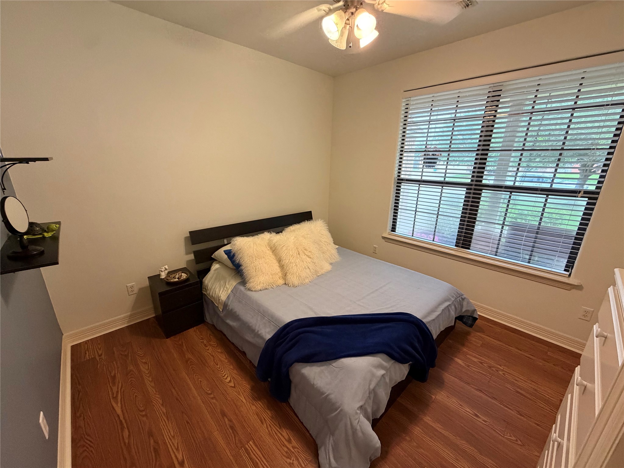 1448 South Blue Bonnet Lane Angleton, TX 77515 - Photo 17 of 43 a bedroom with a bed and a window