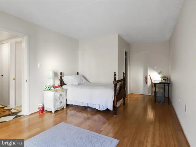 a room with a bed and wooden floor