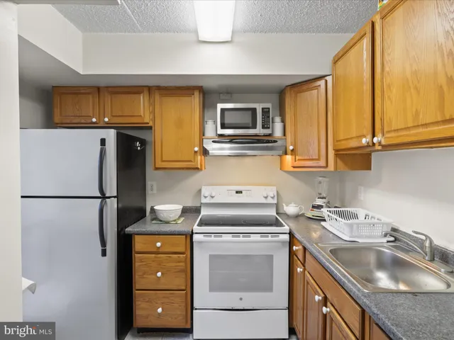 a kitchen with a sink a stove and refrigerator
