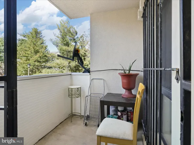 a dining room with furniture and a potted plant