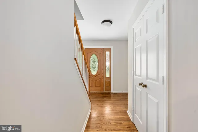 a kitchen with stainless steel appliances granite countertop a sink a stove and a wooden floors
