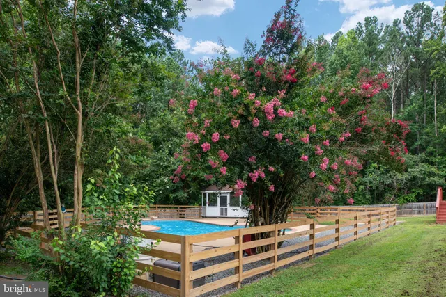 a backyard of a house with a yard and outdoor seating