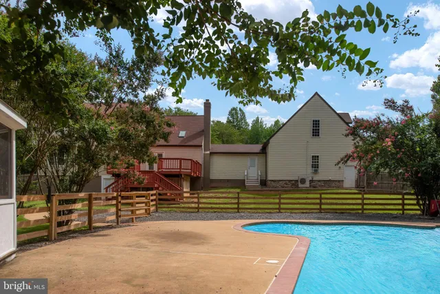 an aerial view of a house with a yard swimming pool and outdoor seating