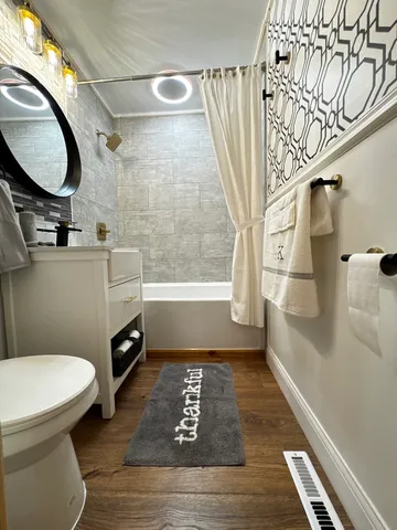 a bathroom with a toilet and a mirror