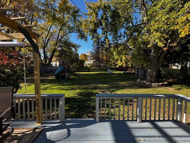 a view of a cafe with a table and chairs under an umbrella