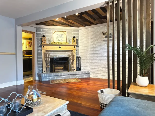 a living room with furniture and a fireplace