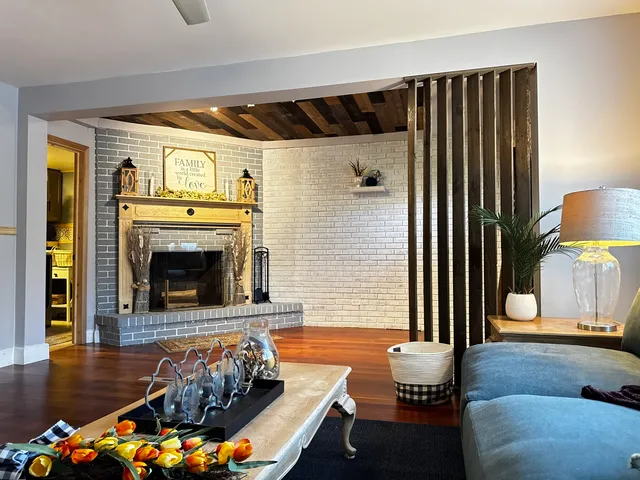 a living room with furniture and a fireplace
