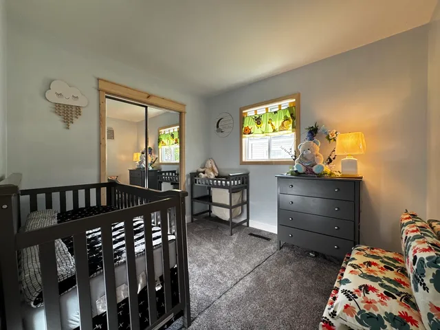 a bedroom with furniture and a window