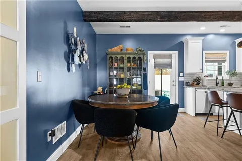 a dining room with furniture and wooden floor