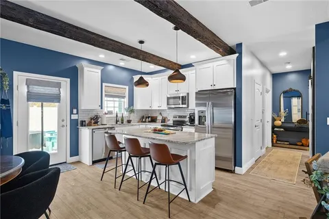 a kitchen with refrigerator a oven and furniture