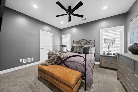 a bathroom with a vase of flowers sink and a mirror