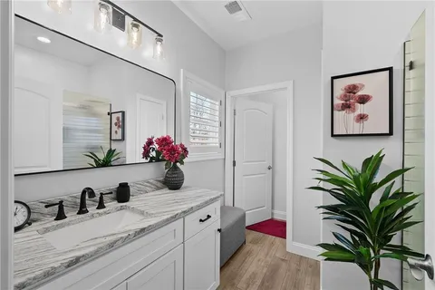 a bedroom with a bed and a potted plant