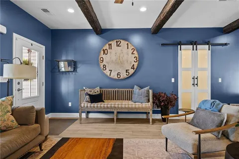 a living room with furniture and a chair