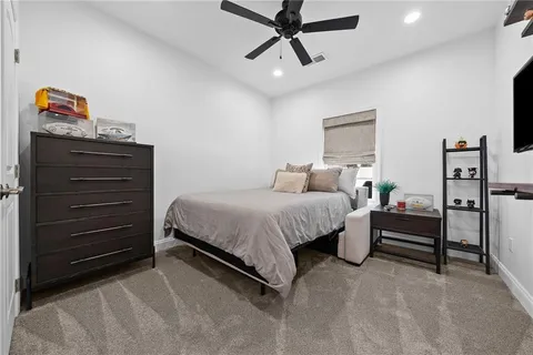 a bedroom with a bed and cabinets