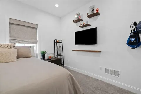 a bathroom with a sink a toilet a mirror and shower