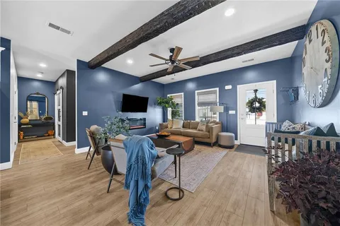 a living room with furniture and a flat screen tv