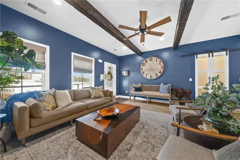 a living room with furniture a clock and a large window