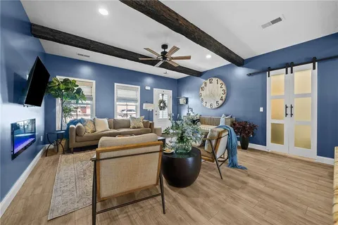 a living room with furniture a fireplace and a flat screen tv