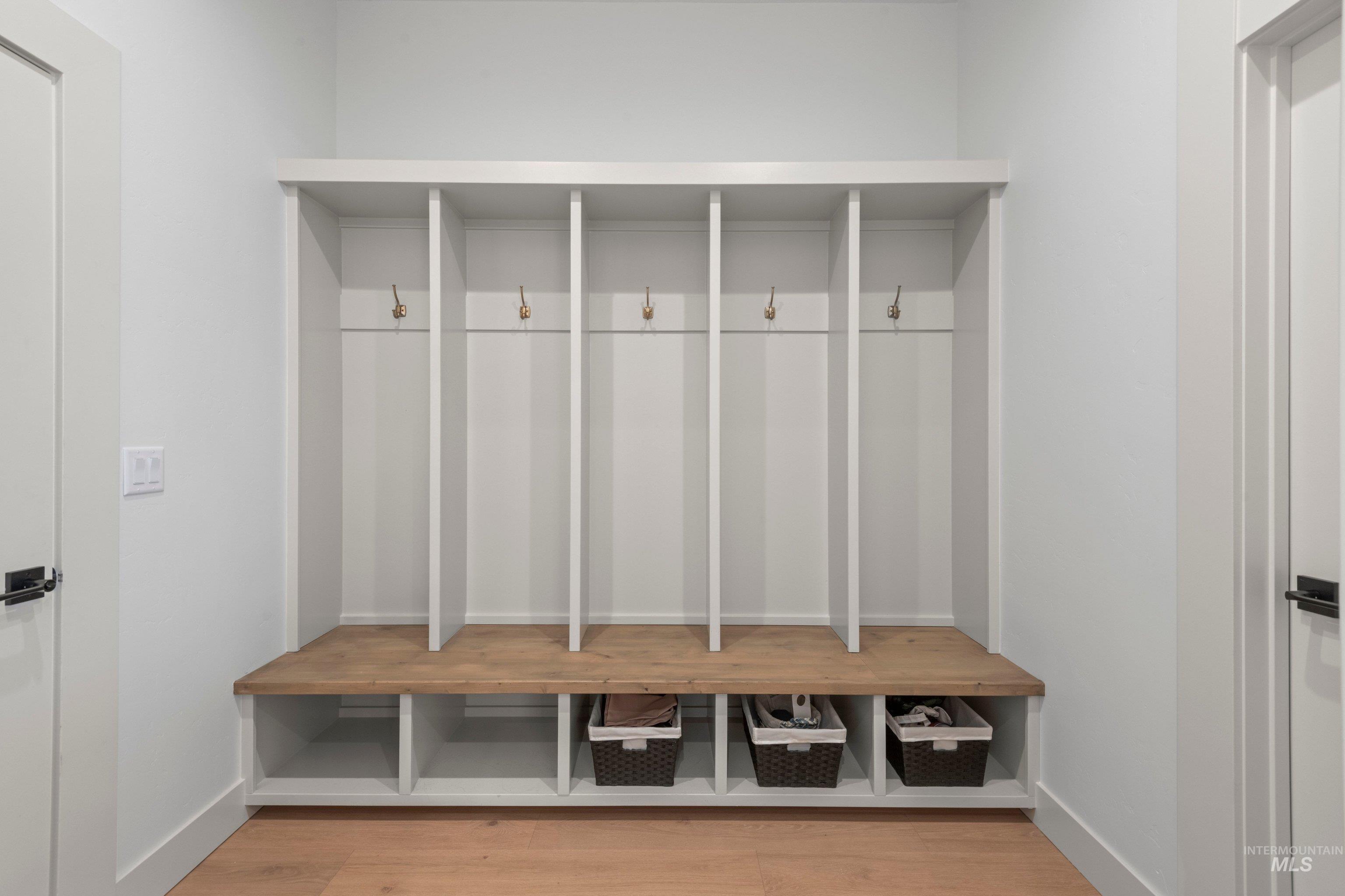 24990 Belgian Way Middleton, ID 83644 - Photo 36 of 50 Built-in cubbies featuring a wood-finish bench, individual storage compartments, and brass hooks