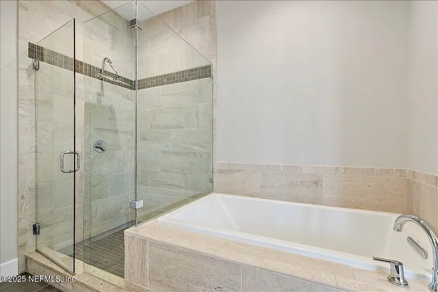 a bathroom with a bathtub and a shower
