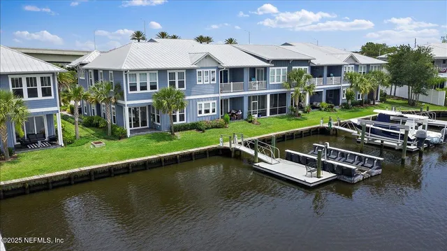 an aerial view of a house with swimming pool patio and lake view