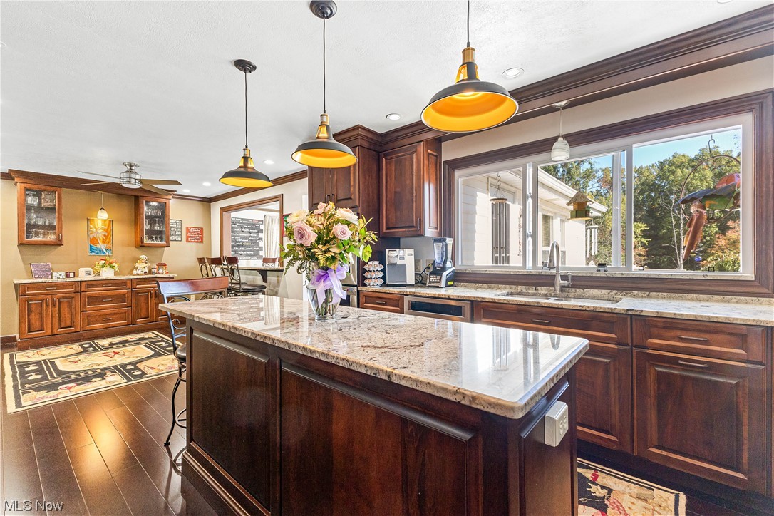 319 Glenview Road Canfield, OH 44406 - Photo 6 of 31 Kitchen with pendant lighting, a kitchen island, dark hardwood floors, and ceiling fan