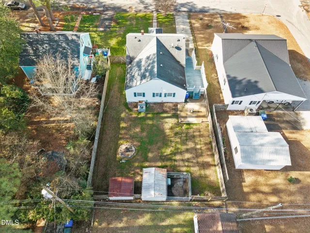 an aerial view of a house with a yard